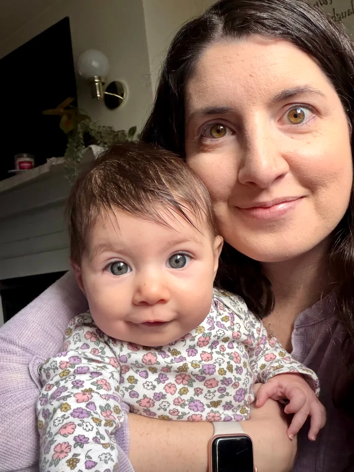 Bethany Barba holding her baby close at home