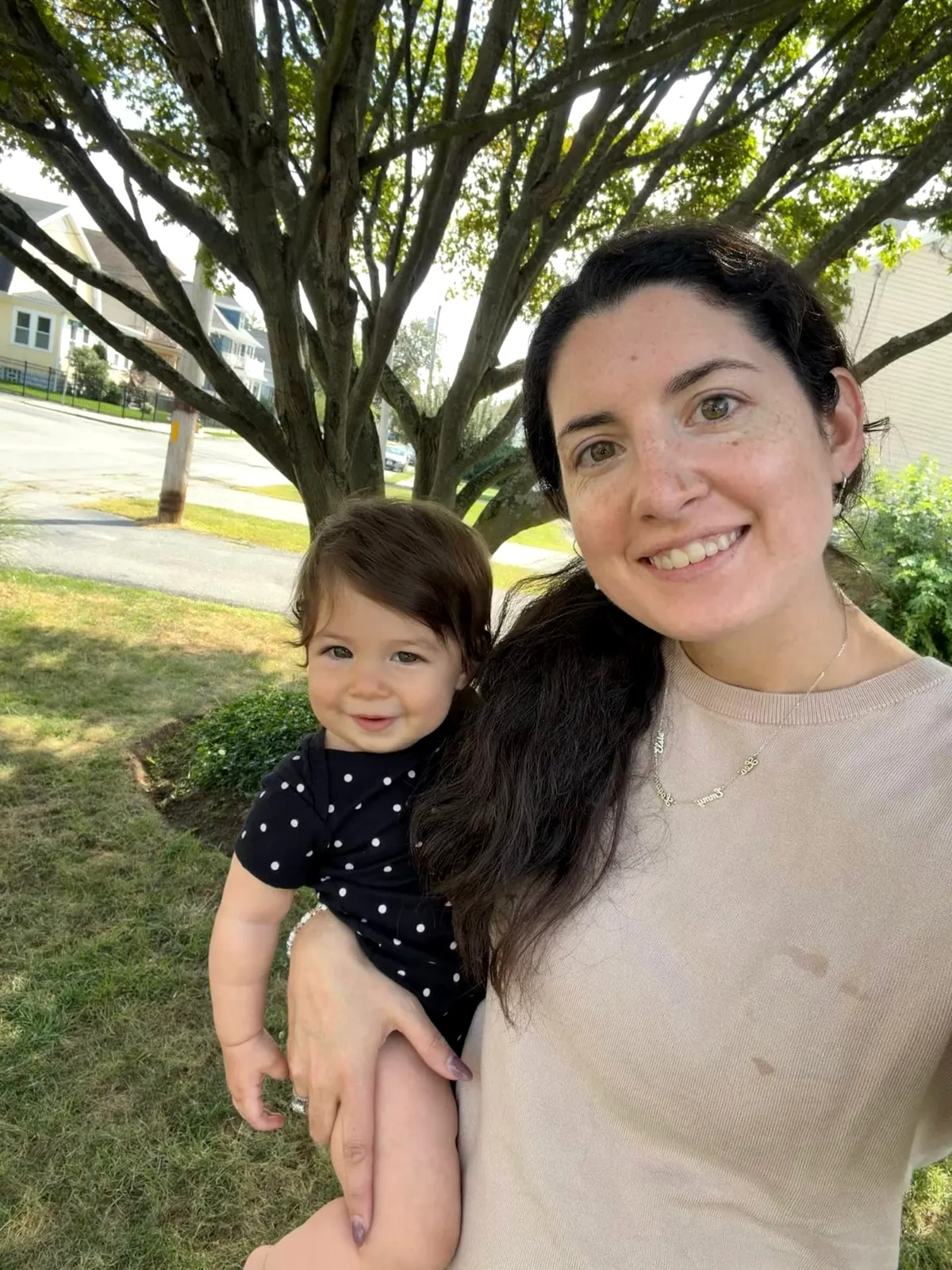 Bethany Barba outdoors holding her smiling baby on her hip